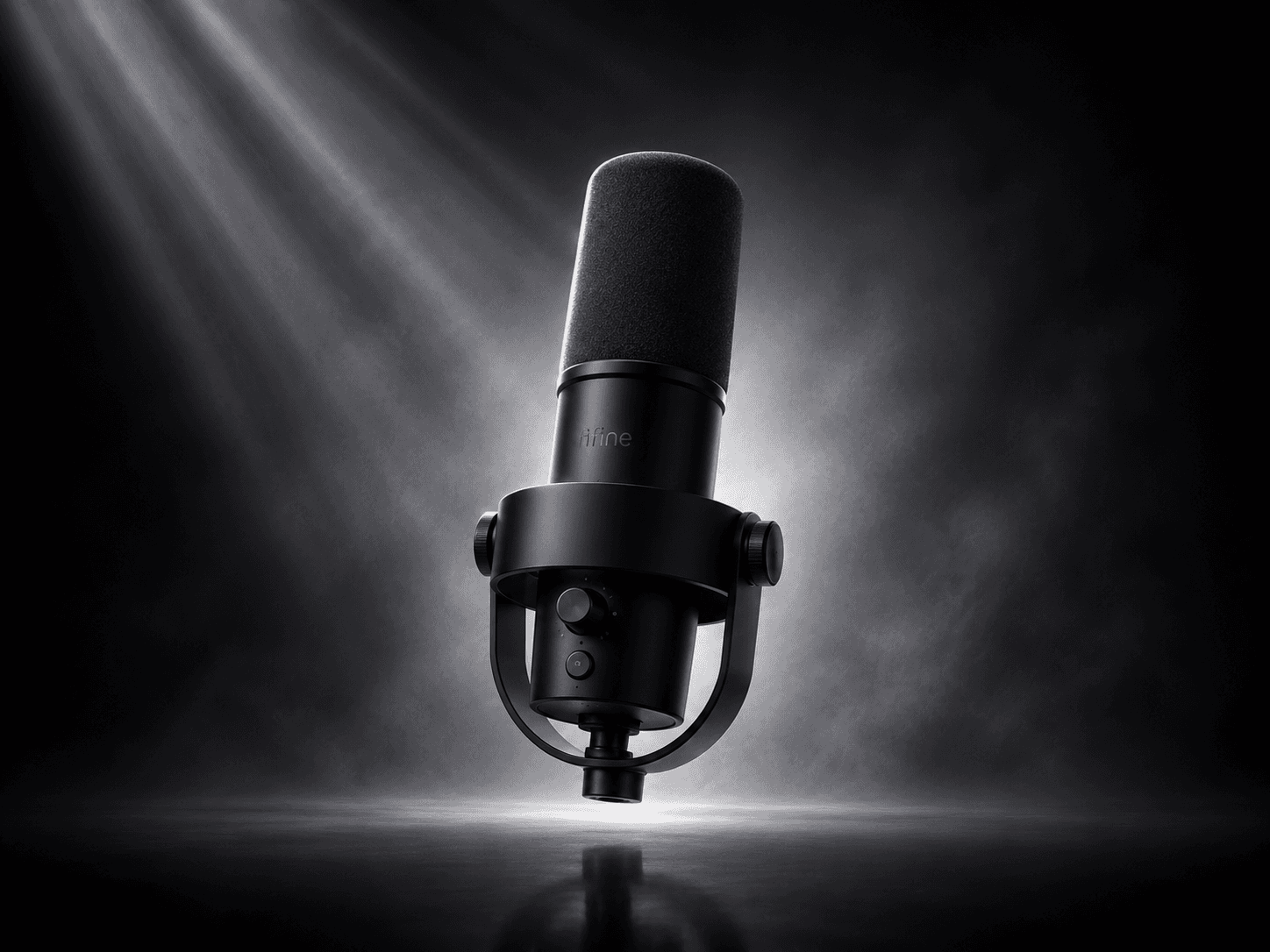 A black FIFINE AmpliTank K688 dynamic microphone on its shock mount, lit dramatically in a dark studio scene.