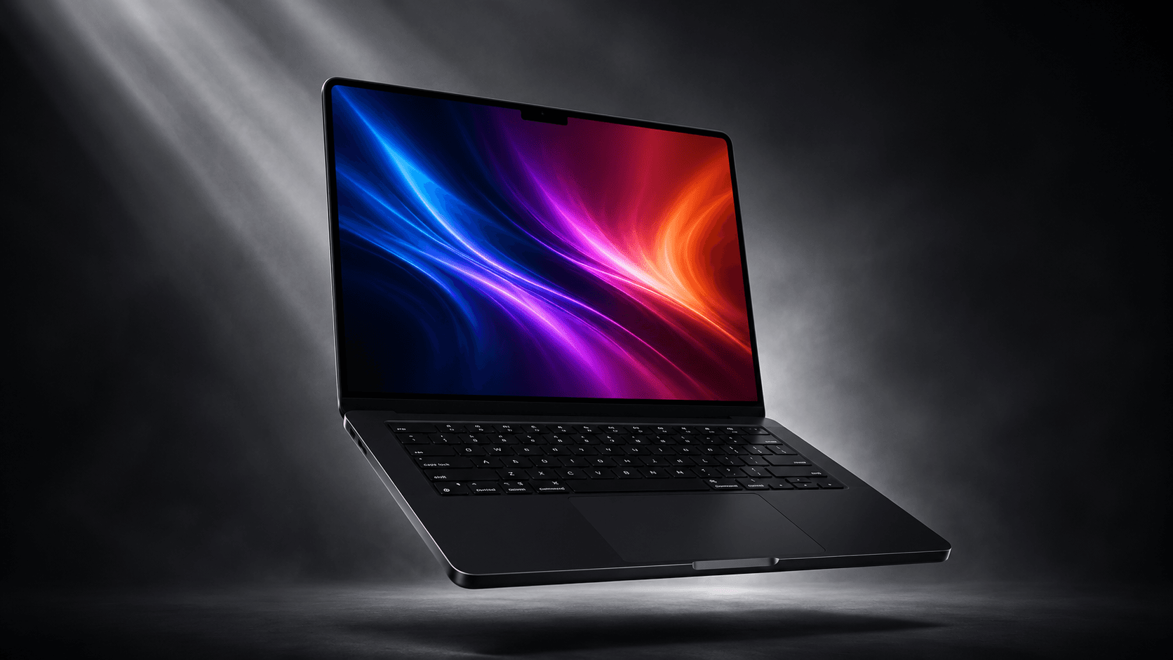 A Space Black MacBook Pro M5 floating at an angle in a spotlit studio scene, its screen glowing with an abstract wallpaper.